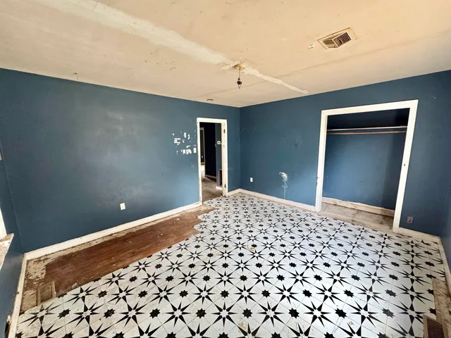 a bedroom with a bed and a lamp