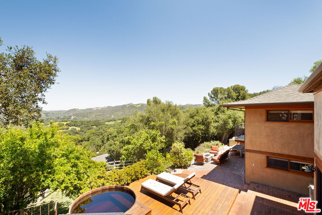 a view of a balcony with couches and wooden floor