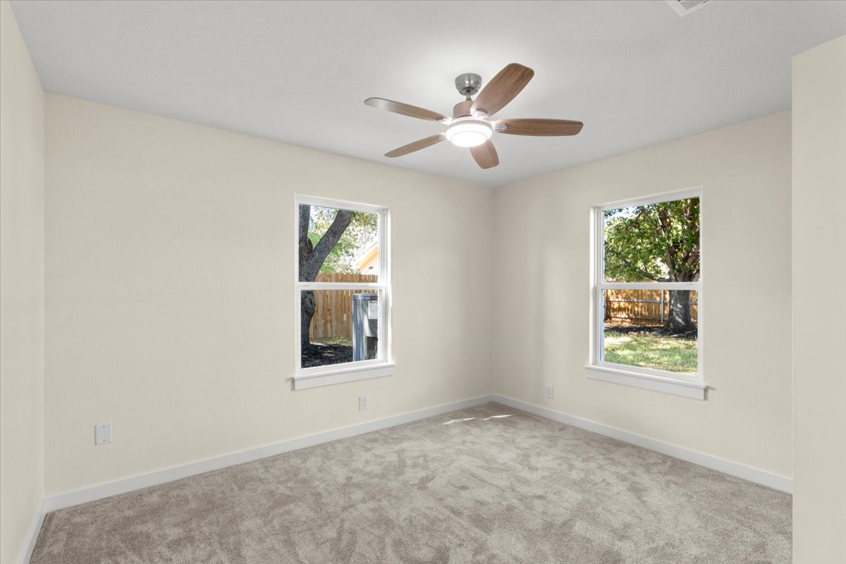 412 Oak Street Bastrop, TX 78602 - Photo 14 of 25 an empty room with windows and fan