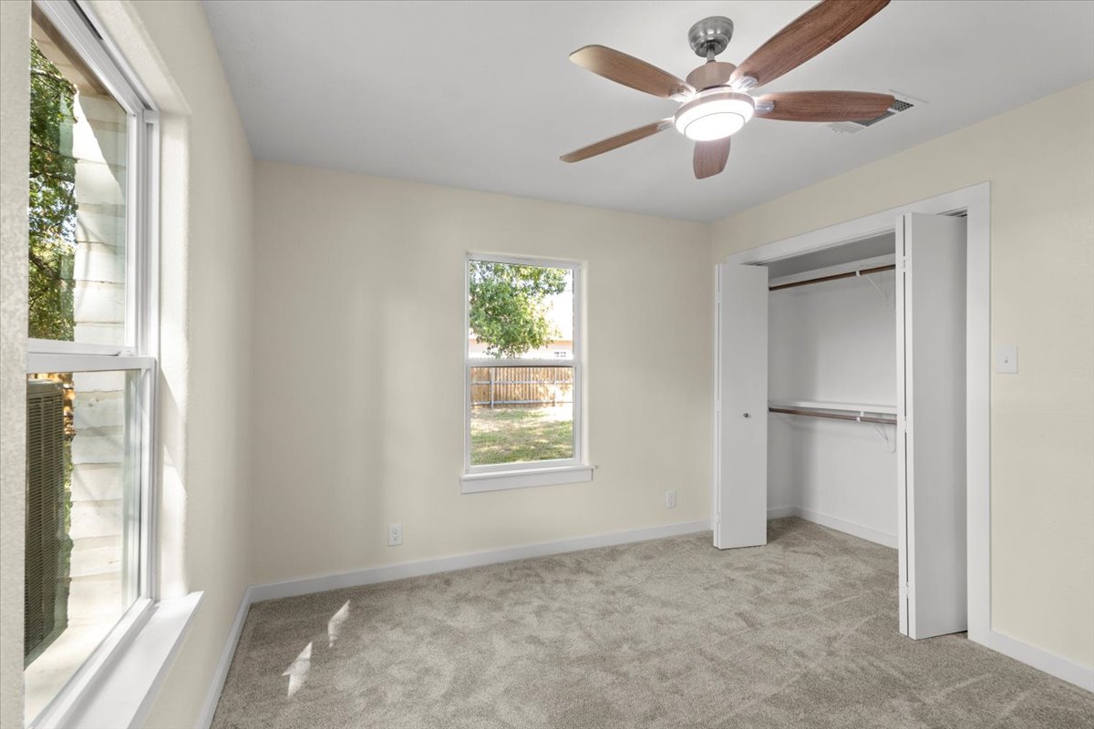 412 Oak Street Bastrop, TX 78602 - Photo 15 of 25 a view of an empty room with a window and a ceiling fan