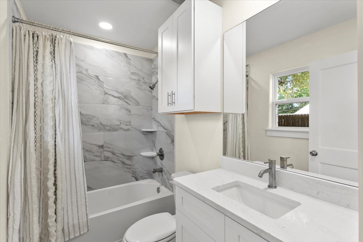 412 Oak Street Bastrop, TX 78602 - Photo 20 of 25 a bathroom with a sink toilet and shower