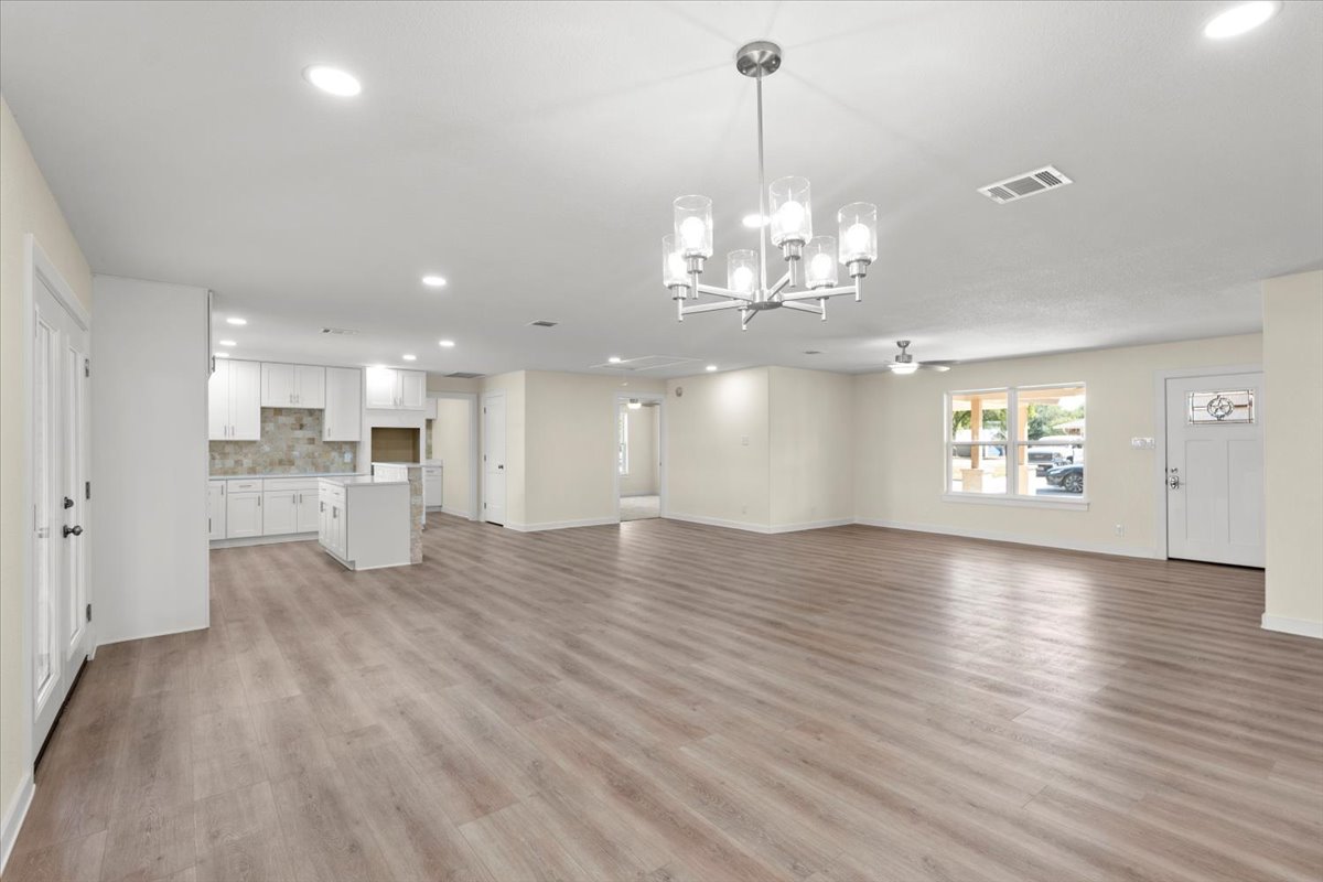 412 Oak Street Bastrop, TX 78602 - Photo 21 of 25 a view of an empty room and kitchen with wooden floor