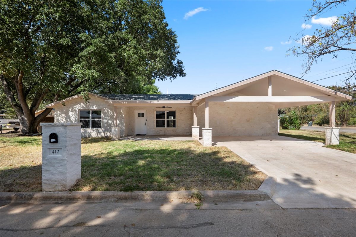412 Oak Street Bastrop, TX 78602 - Photo 3 of 25 a front view of a house with a yard and garage