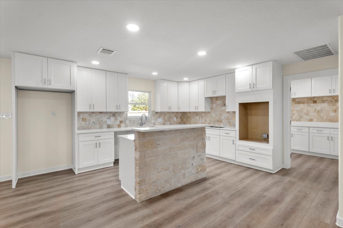 412 Oak Street Bastrop, TX 78602 - Photo 5 of 25 a kitchen with white cabinets and refrigerator