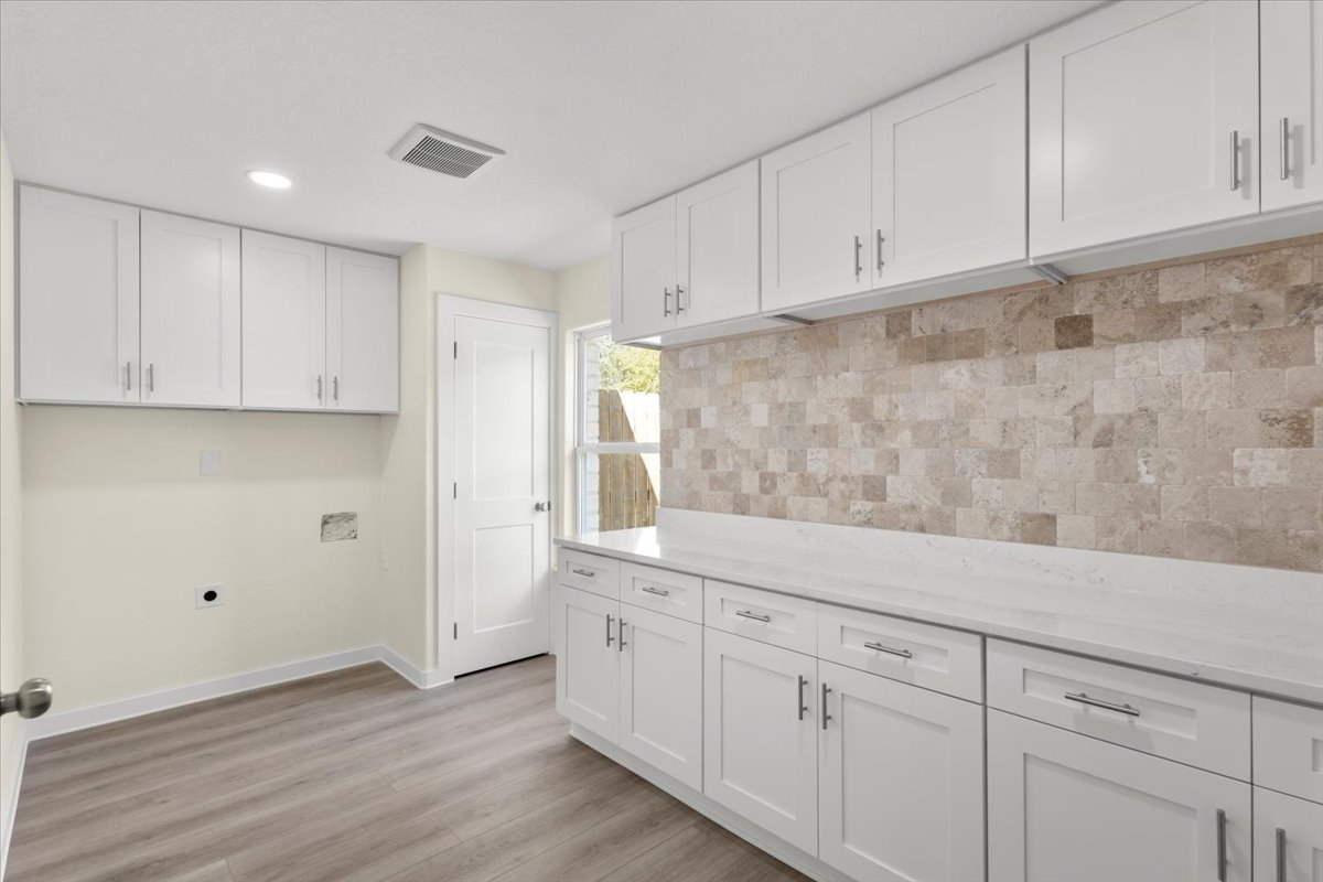 412 Oak Street Bastrop, TX 78602 - Photo 9 of 25 a view of cabinets and wooden floor