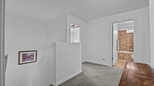 a view of a livingroom with wooden floor and window