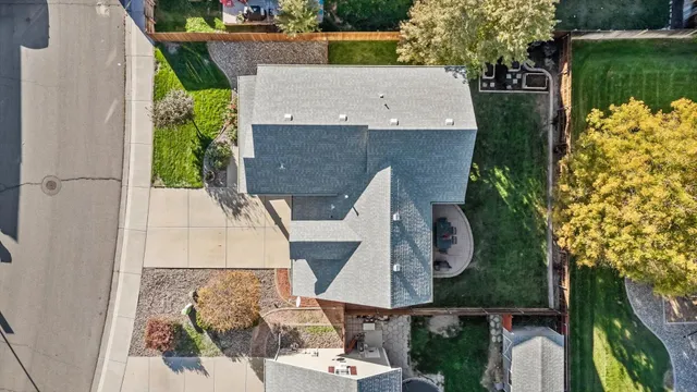 an aerial view of a house with a garden and trees