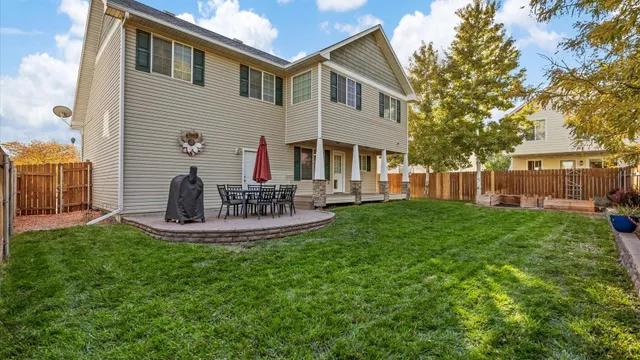 a front view of a house with a yard porch and outdoor seating