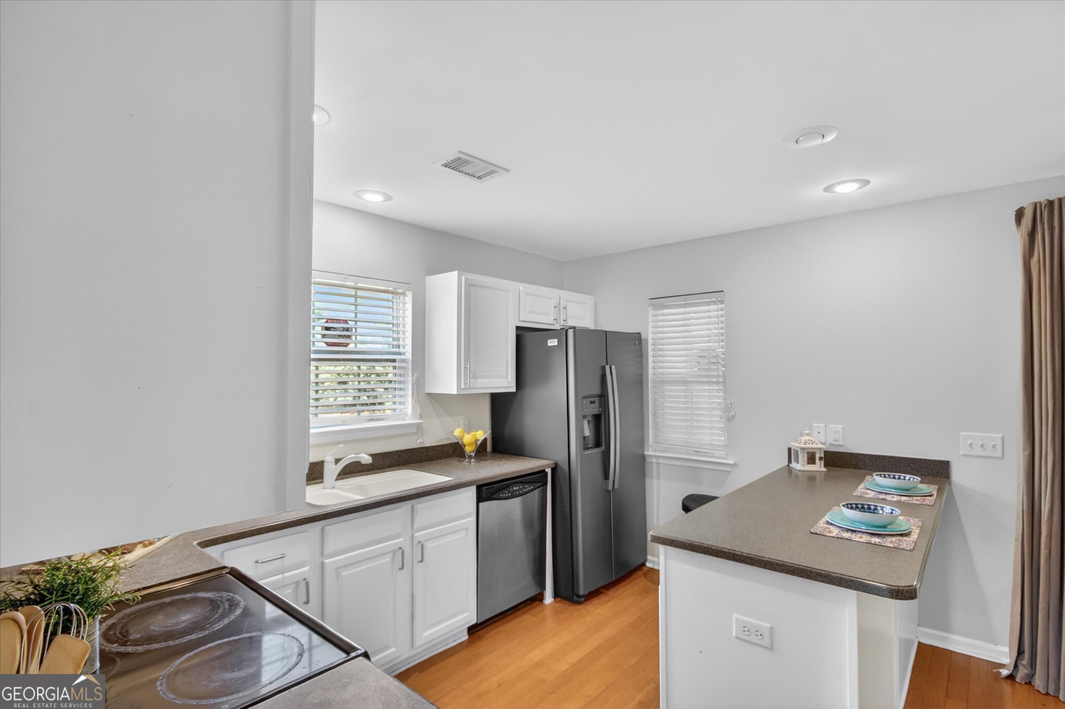 172 Sonata Circle Pooler, GA 31322 - Photo 24 of 85 a kitchen with stainless steel appliances granite countertop a refrigerator and a stove top oven