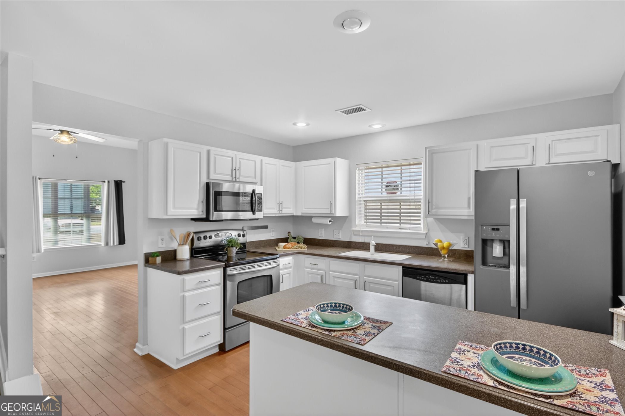 172 Sonata Circle Pooler, GA 31322 - Photo 26 of 85 a kitchen with stainless steel appliances granite countertop a sink stove refrigerator and cabinets