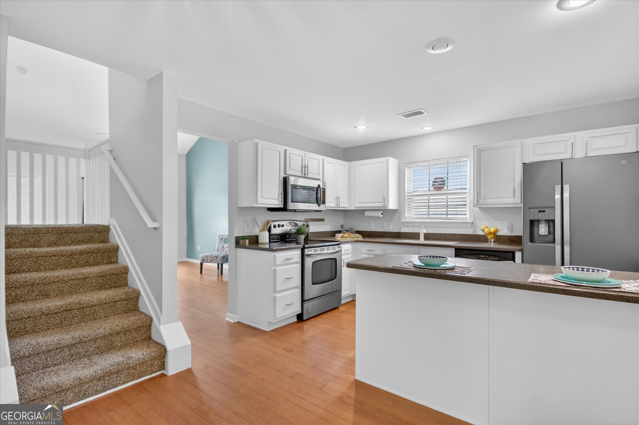 172 Sonata Circle Pooler, GA 31322 - Photo 34 of 85 a kitchen with white cabinets and stainless steel appliances