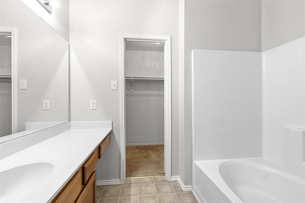 3521 Apple Valley Way Dallas, TX 75227 - Photo 12 of 25 a bathroom with a bathtub and a sink
