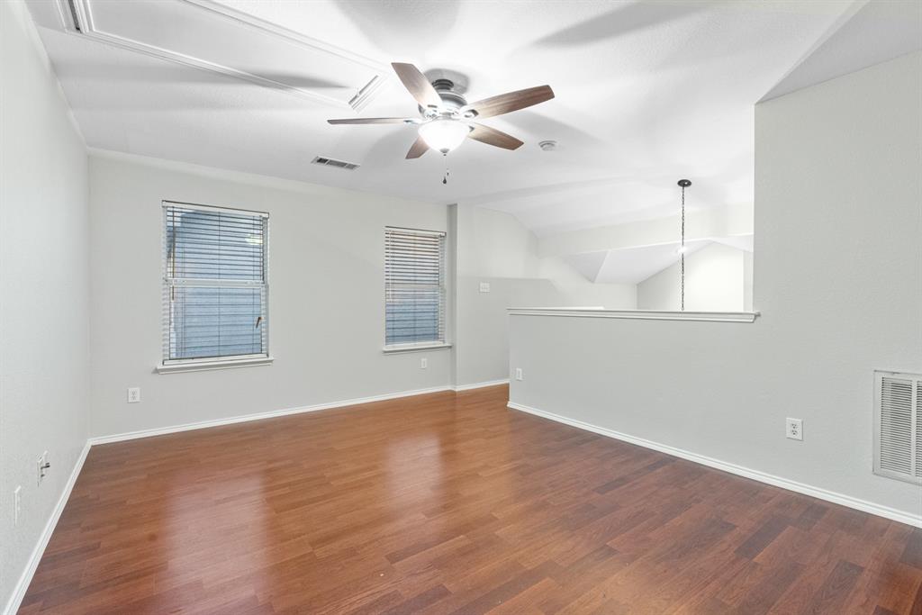 3521 Apple Valley Way Dallas, TX 75227 - Photo 15 of 25 an empty room with wooden floor fan and windows