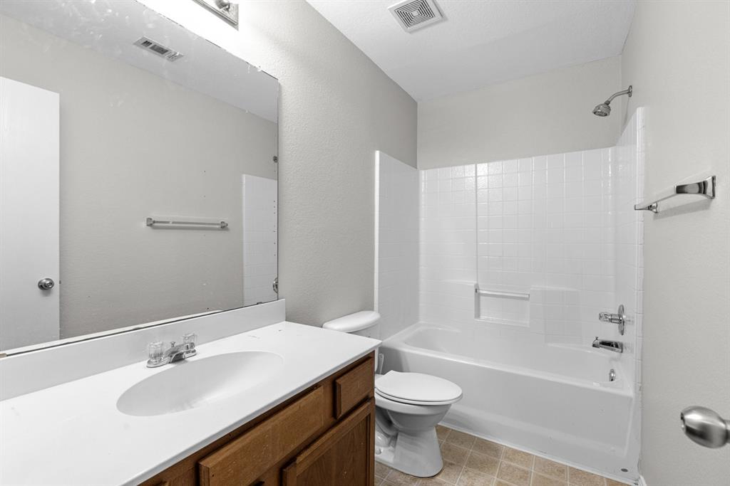 3521 Apple Valley Way Dallas, TX 75227 - Photo 17 of 25 a bathroom with a sink toilet and shower