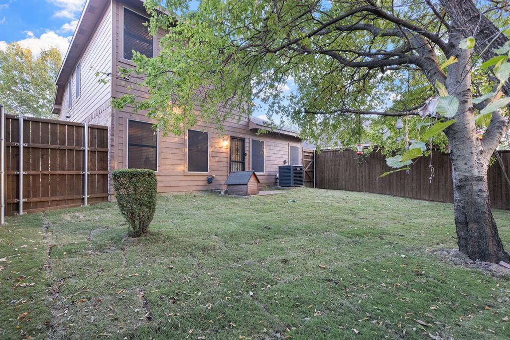 3521 Apple Valley Way Dallas, TX 75227 - Photo 21 of 25 a view of a house with backyard and a tree