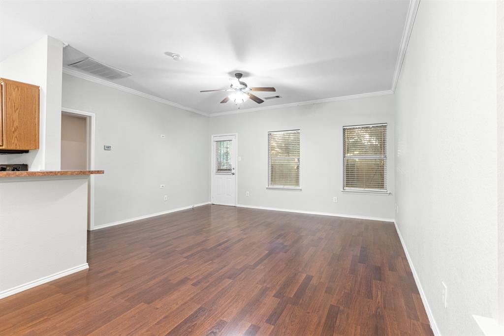 3521 Apple Valley Way Dallas, TX 75227 - Photo 3 of 25 a view of an empty room with window and wooden floor