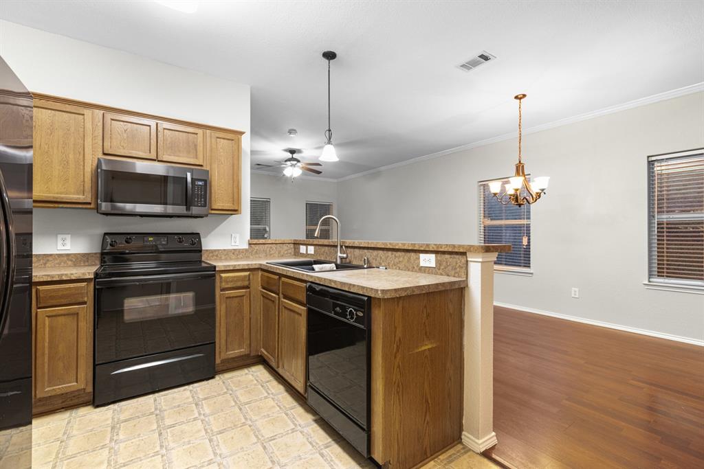 3521 Apple Valley Way Dallas, TX 75227 - Photo 6 of 25 a kitchen with kitchen island stainless steel appliances a stove sink and microwave