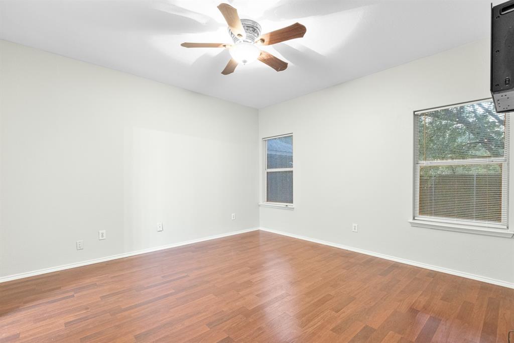 3521 Apple Valley Way Dallas, TX 75227 - Photo 8 of 25 an empty room with wooden floor and windows