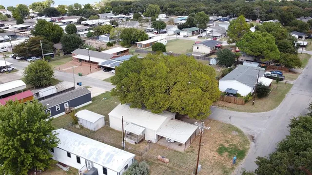 an aerial view of a house with yard swimming pool and outdoor seating