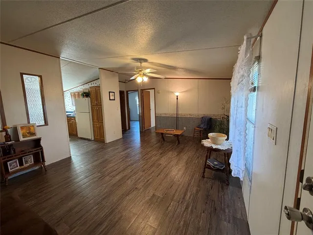 a view of a hallway and wooden floor with a glass door
