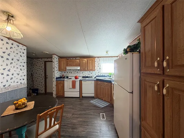 a kitchen with refrigerator and window