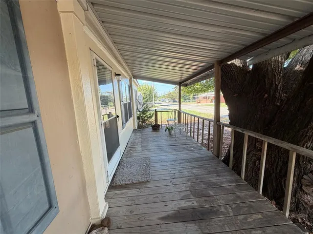 a view of a porch with wooden floor