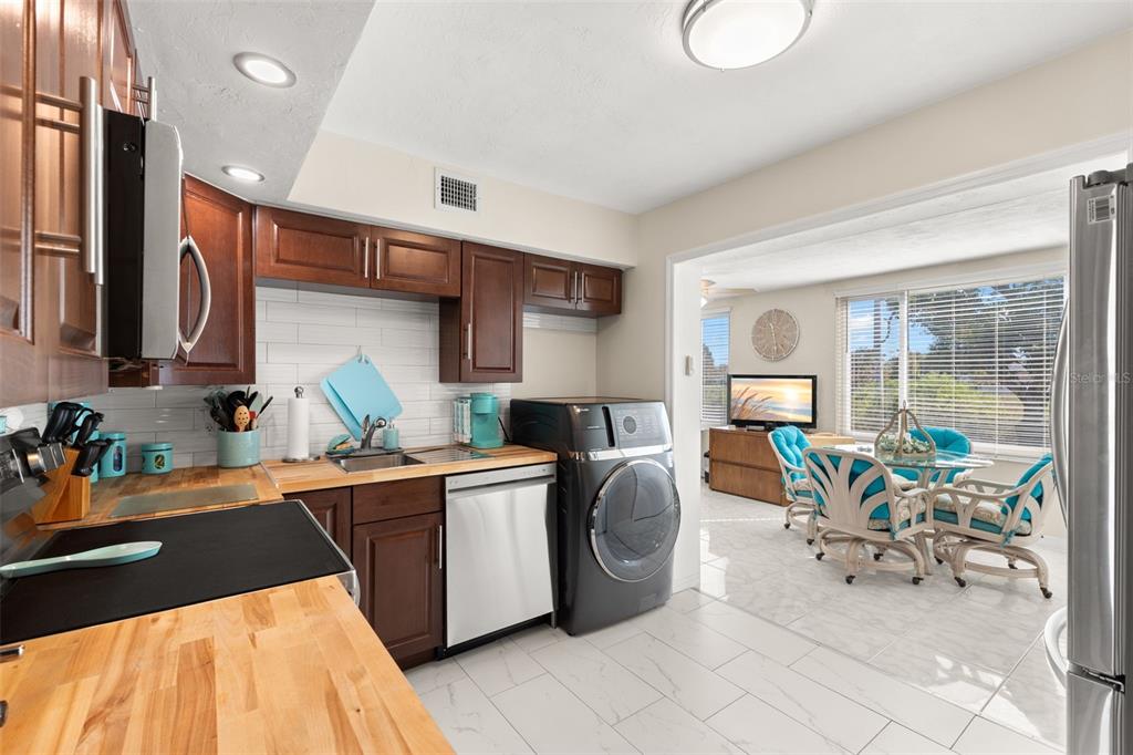 2461 Canadian Way, Unit 27 Clearwater, FL 33763 - Photo 13 of 35 a kitchen with stainless steel appliances kitchen island granite countertop a sink and cabinets