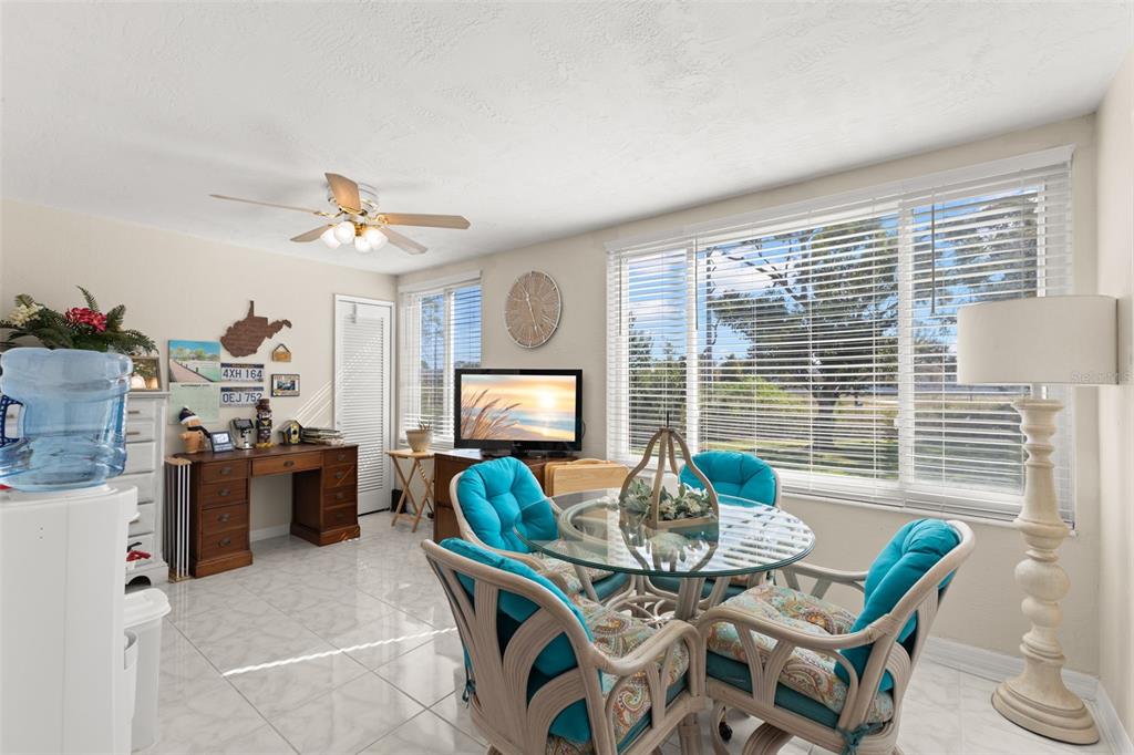 2461 Canadian Way, Unit 27 Clearwater, FL 33763 - Photo 16 of 35 a view of a dining room with furniture and a chandelier