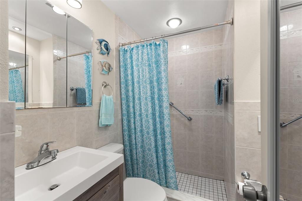 2461 Canadian Way, Unit 27 Clearwater, FL 33763 - Photo 21 of 35 a bathroom with a sink toilet and shower