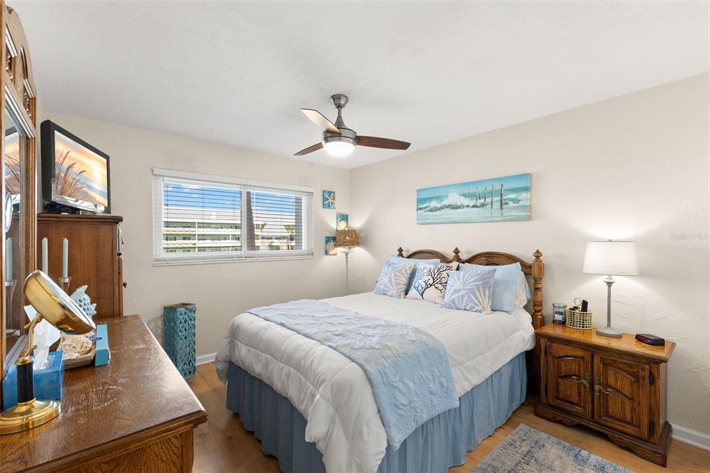 2461 Canadian Way, Unit 27 Clearwater, FL 33763 - Photo 23 of 35 a bedroom with a bed and wooden floor