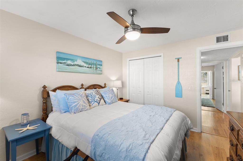2461 Canadian Way, Unit 27 Clearwater, FL 33763 - Photo 24 of 35 a bedroom with a bed and a chandelier