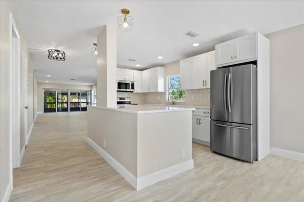 a kitchen with stainless steel appliances a refrigerator stove microwave and cabinets
