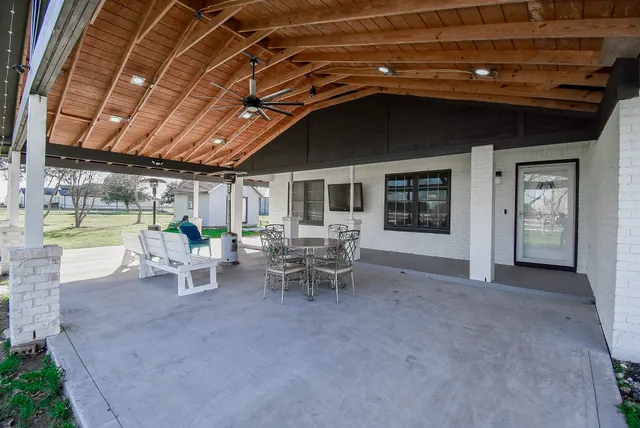 a view of a patio with table and chairs and potted plants