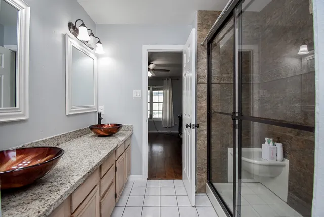 a bathroom with a glass shower door