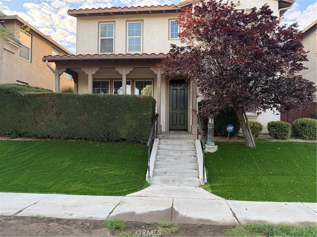a front view of a house with a garden