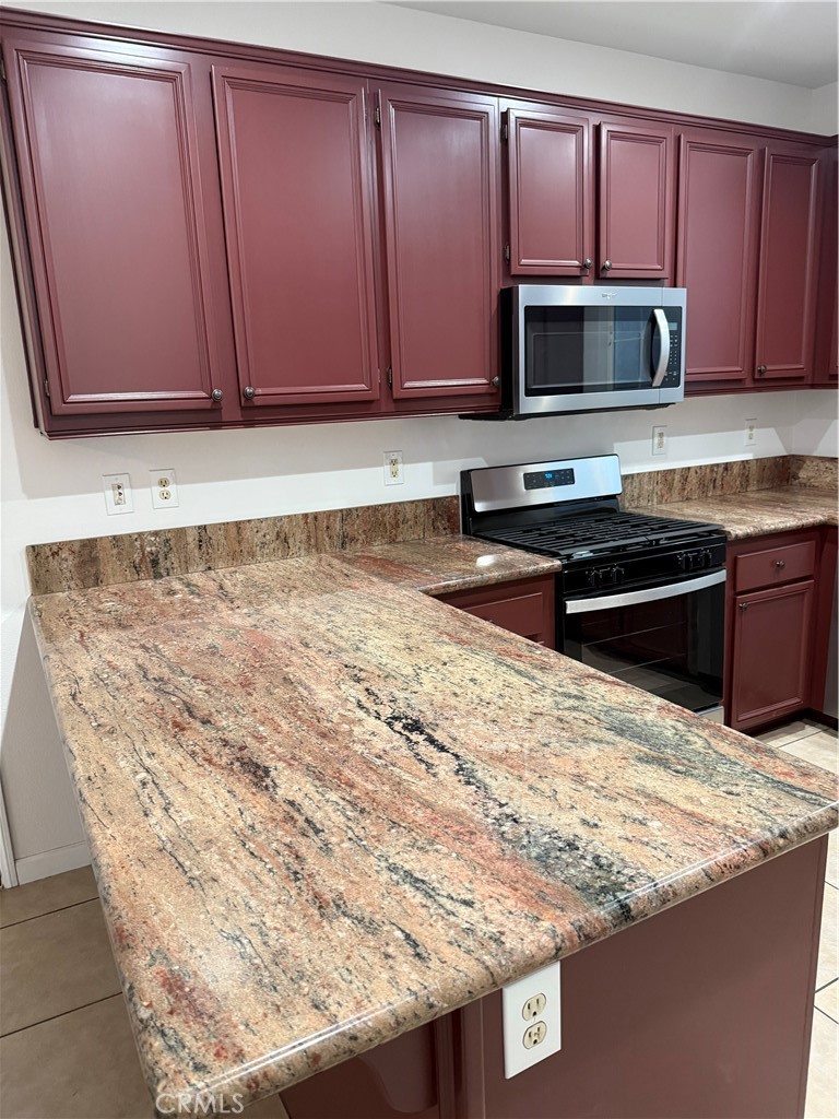 26015 Reed Way Loma Linda, CA 92354 - Photo 12 of 15 a kitchen with granite countertop sink cabinets and stainless steel appliances