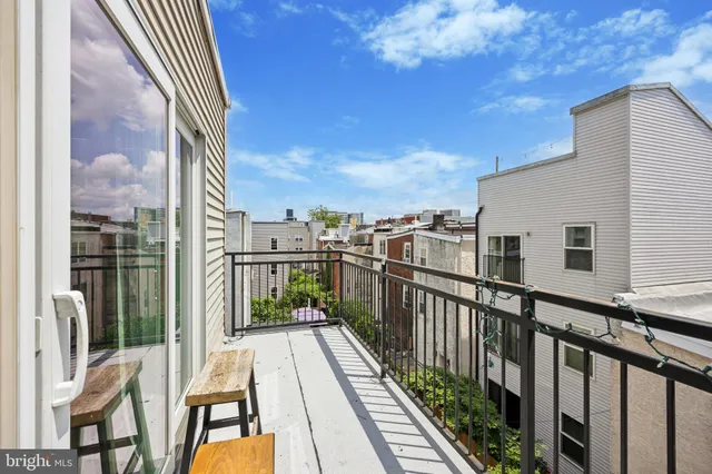 a view of a balcony with wooden floor and fence