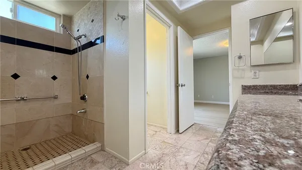 a bathroom with a glass shower door and a sink