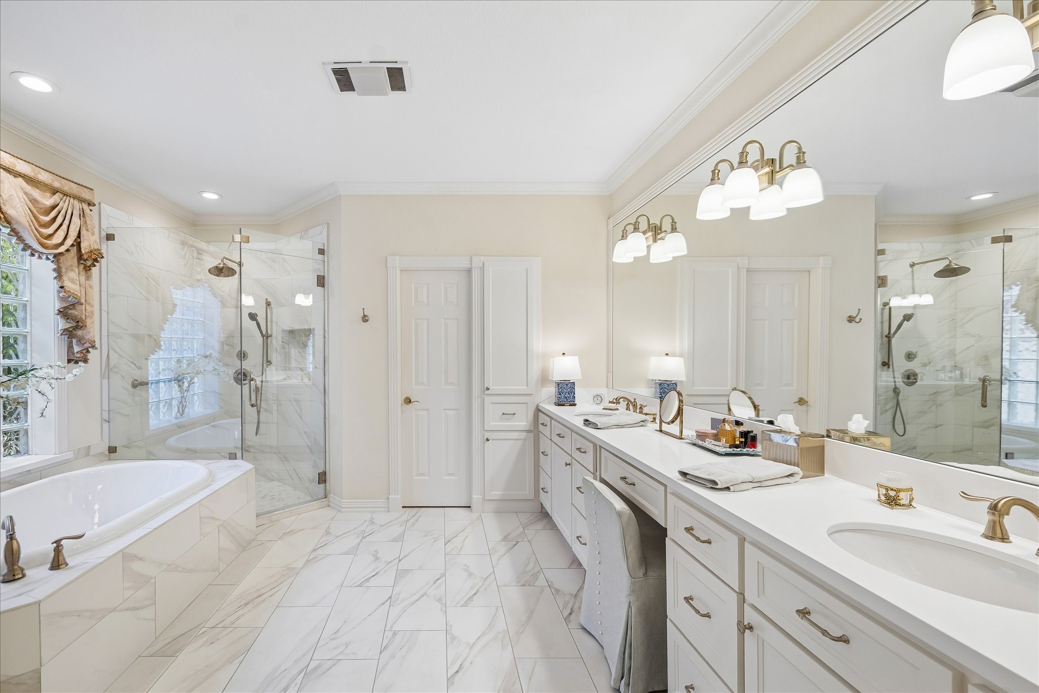 6611 Trebeck Lane Spring, TX 77379 - Photo 19 of 33 Spa-inspired primary bath featuring dual vanities, extensive counter space, elegant finishes, and a bright, open layout.
