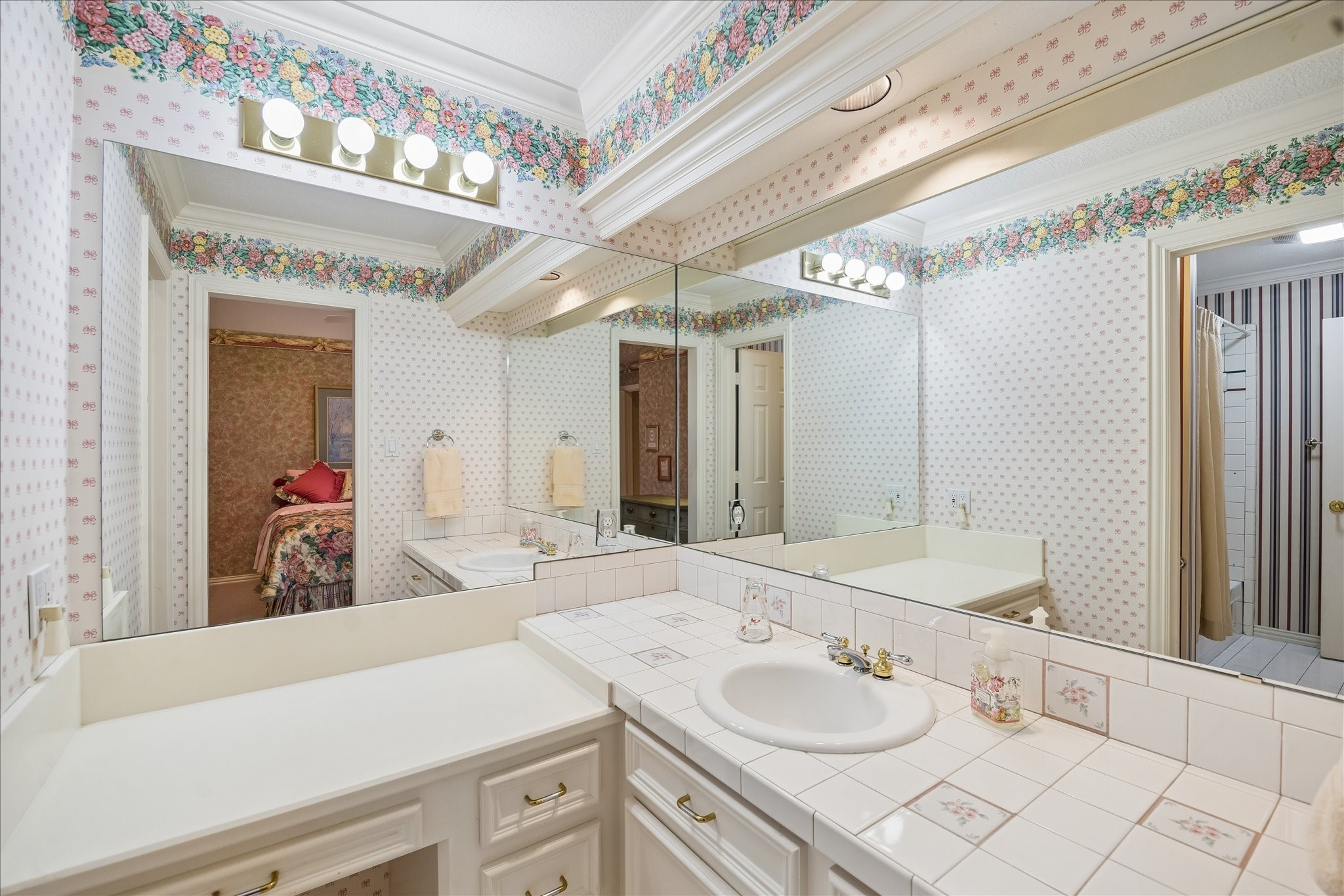 6611 Trebeck Lane Spring, TX 77379 - Photo 28 of 33 Bright secondary bathroom vanity area with ample counter space and functional layout, conveniently connected to adjacent bedroom.