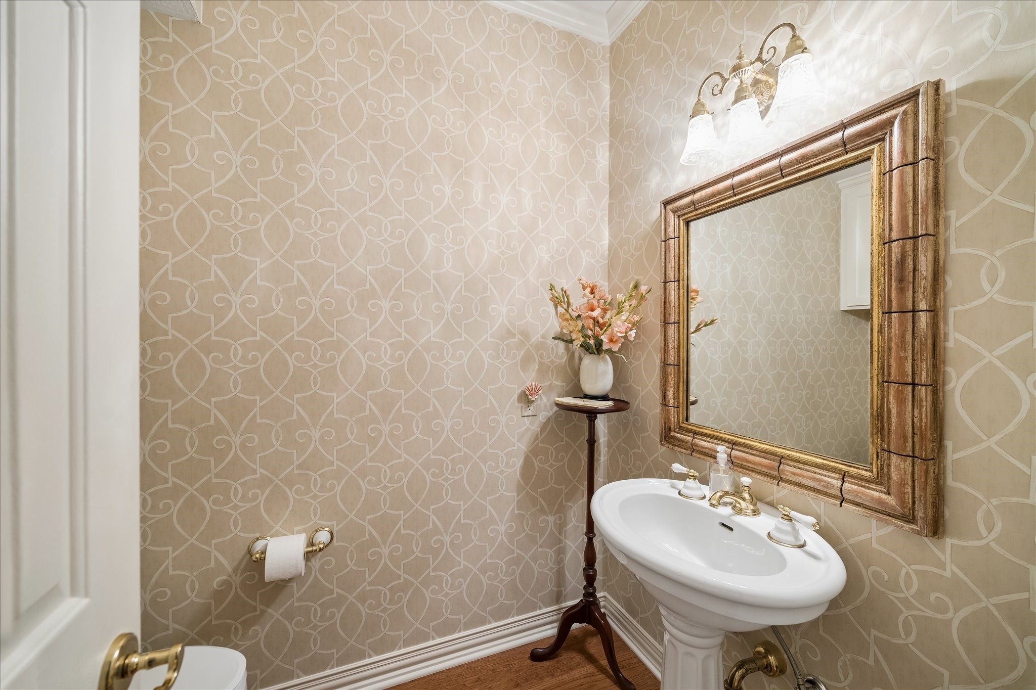 6611 Trebeck Lane Spring, TX 77379 - Photo 29 of 33 Elegant powder bath featuring designer wallpaper, pedestal sink, and classic finishes. Conveniently located on the first level near the stairs.