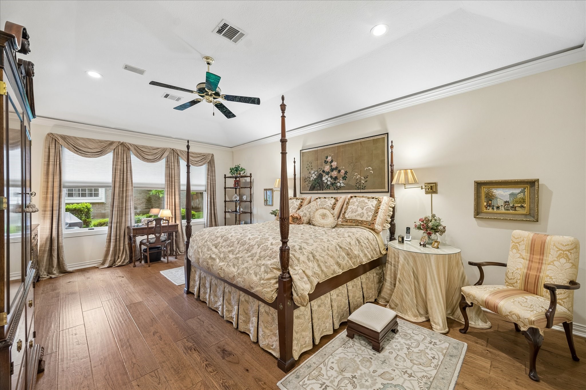 6611 Trebeck Lane Spring, TX 77379 - Photo 4 of 33 Spacious primary suite with wood flooring, high ceilings, and large windows that fill the room with natural light.