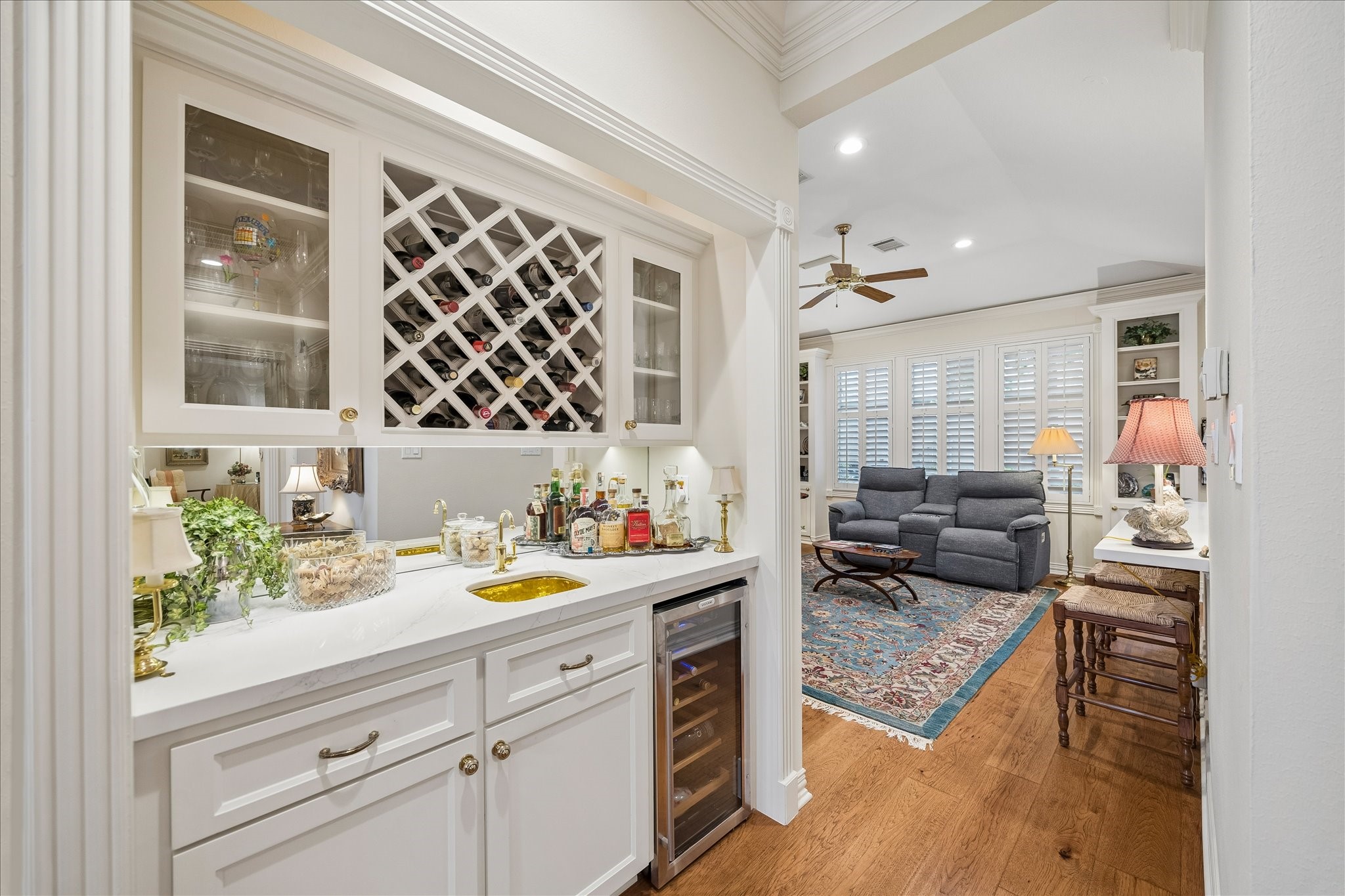 6611 Trebeck Lane Spring, TX 77379 - Photo 10 of 33 Custom built-in bar with wine storage, glass display cabinetry, and beverage fridge, perfect for entertaining and showcasing your collection.