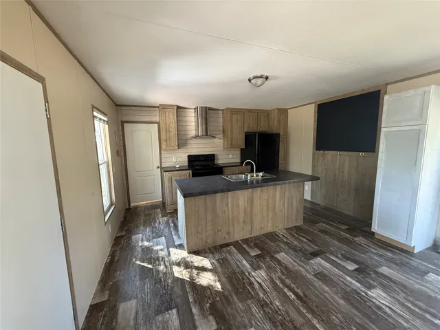 a kitchen with stainless steel appliances a refrigerator and a stove top oven