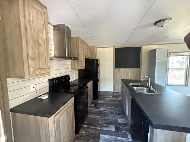 a kitchen with a sink stove and refrigerator