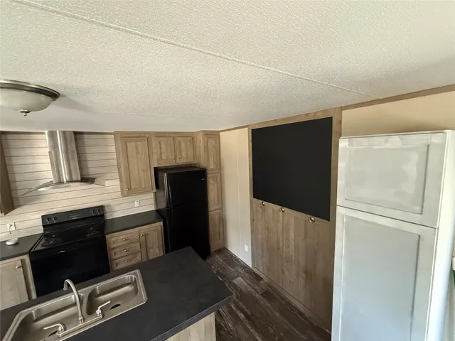 a kitchen with a refrigerator and cabinets