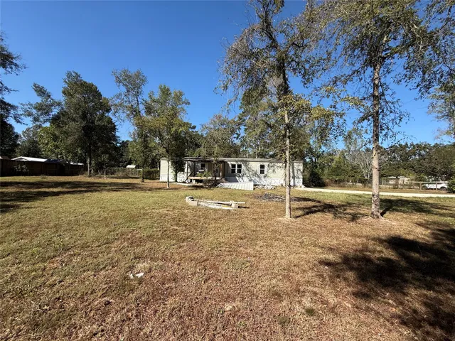a view of road with large trees