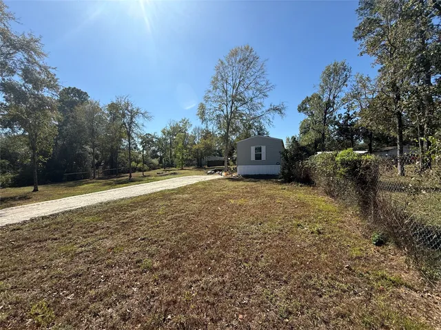 a view of a field with some trees in the background