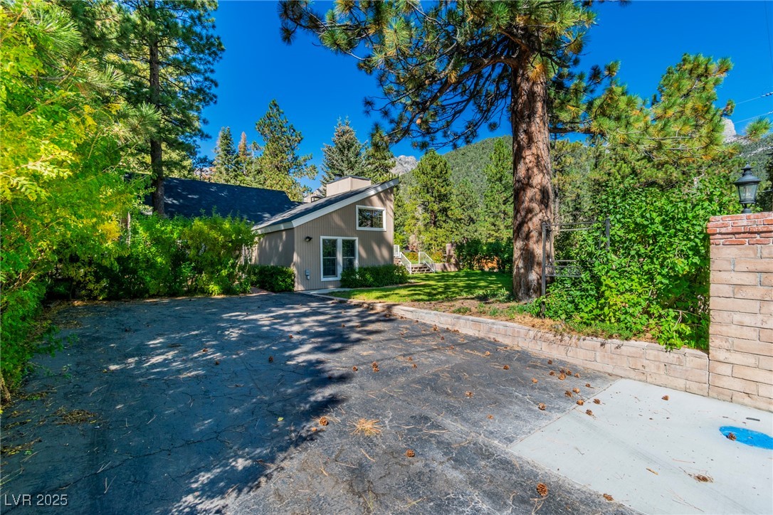 4063 Zugspitz Way Las Vegas, NV 89124 - Photo 11 of 86 View of home's exterior with a yard