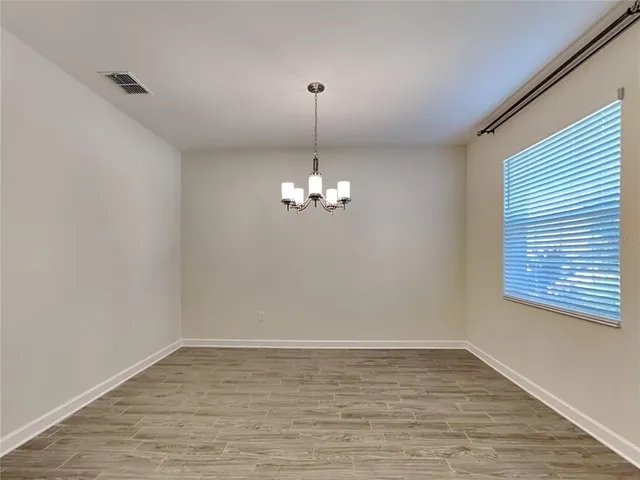 a view of a chandelier fan and wooden floor